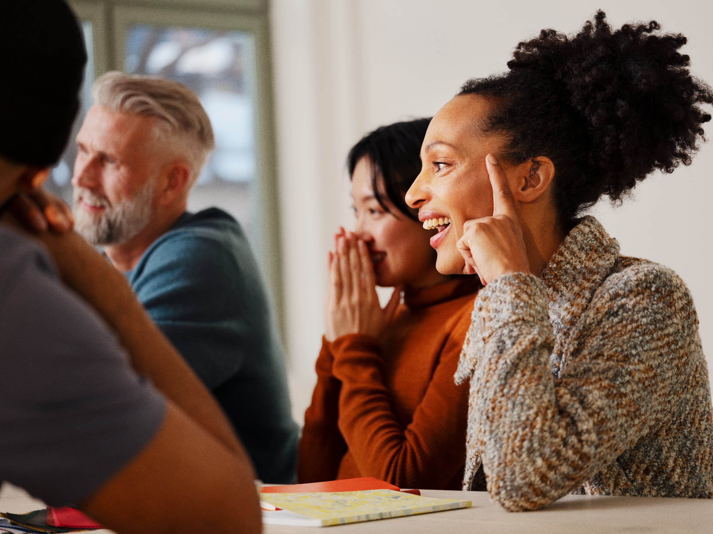 Group of people engaged in talk, looking happy